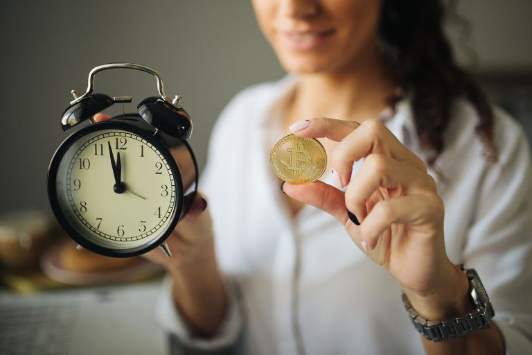 More Companies Hold Bitcoin on Their Balance Sheets bitcoin coin in front of trading charts